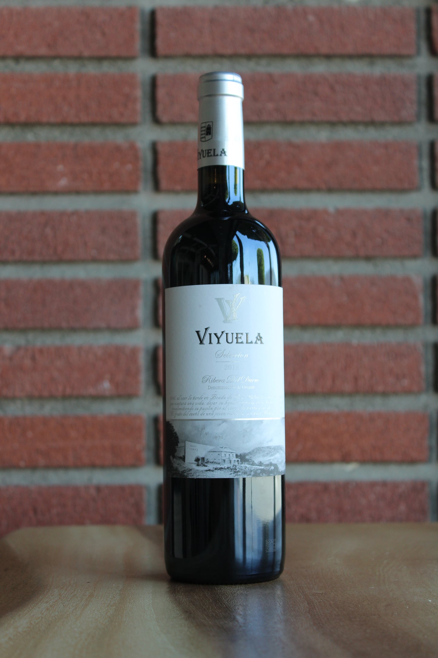 bottle of bodegas viyeula seleccion crianza tempranillo on a brick background