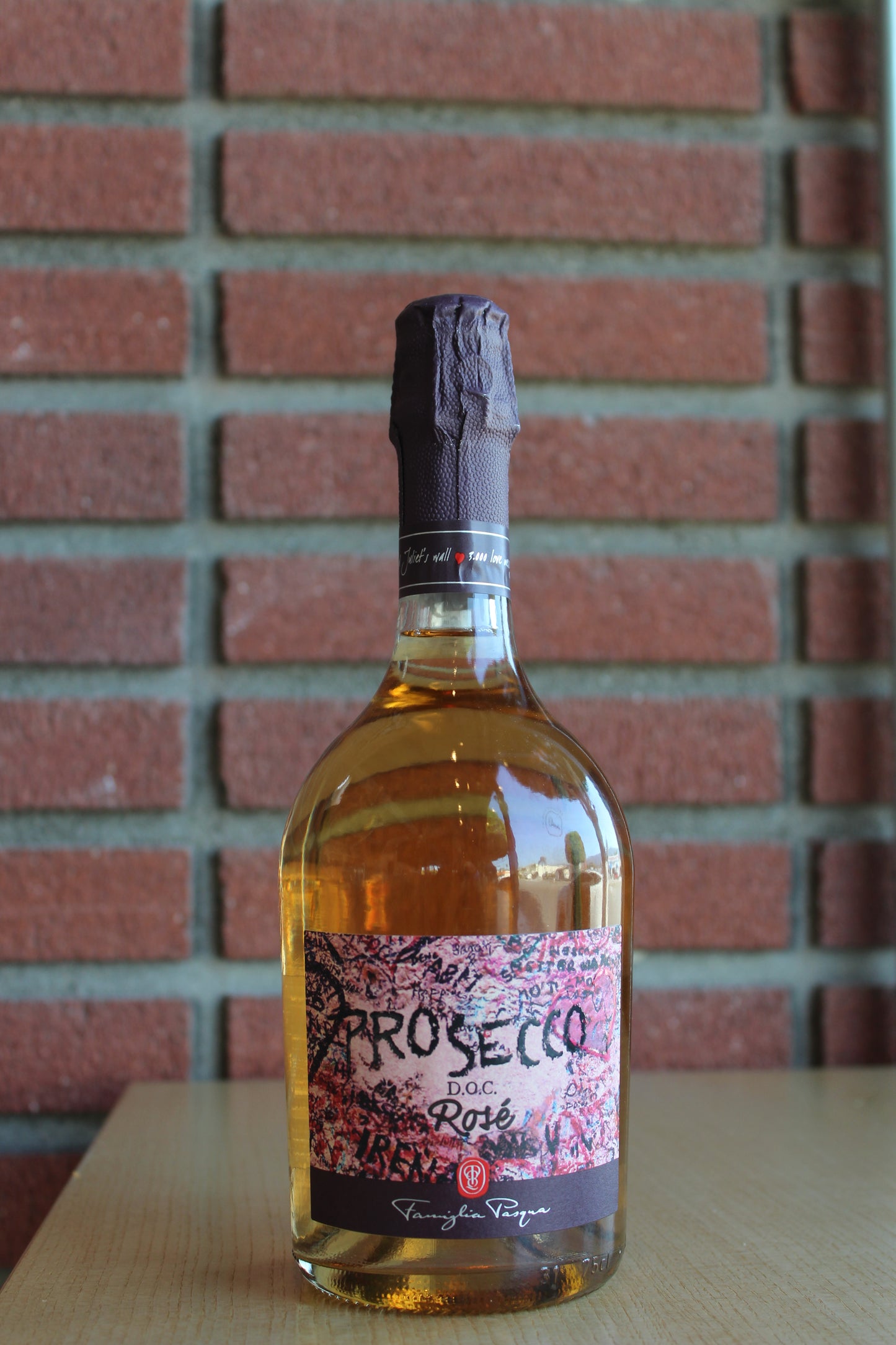 Famiglia Pasqua Romeo and Juliet Prosecco Rose Bottle on a brick background