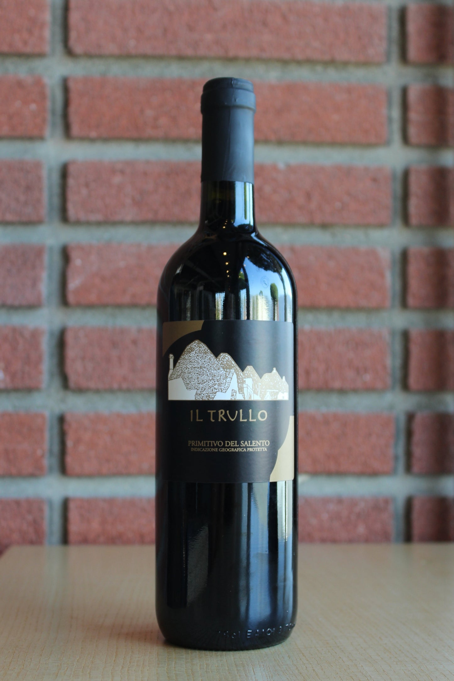 Il Trullo Primitivo Salento Bottle on a brick background