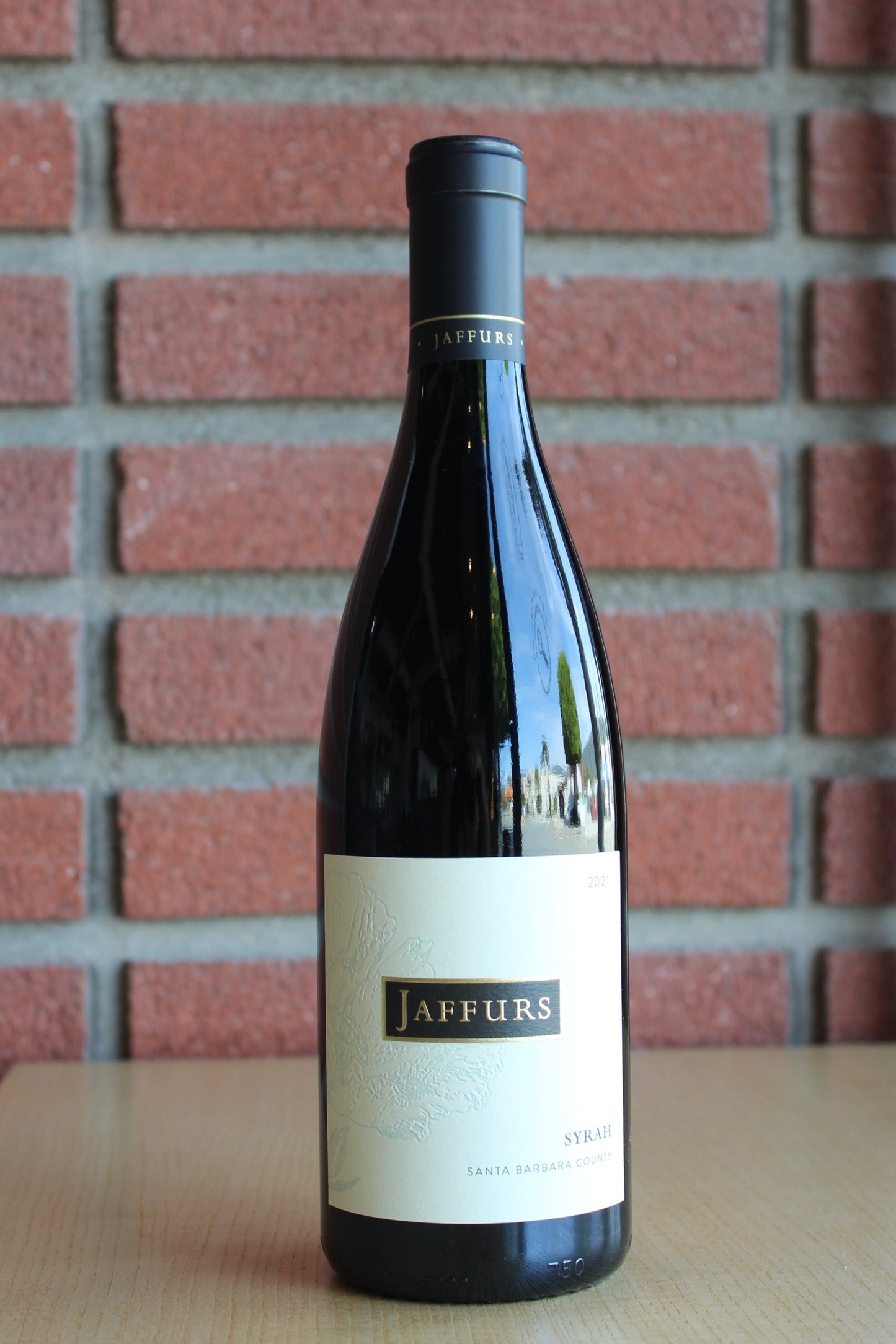 Jaffurs Wine Cellars Syrah Santa Barbara County 2021 Bottle on a brick background