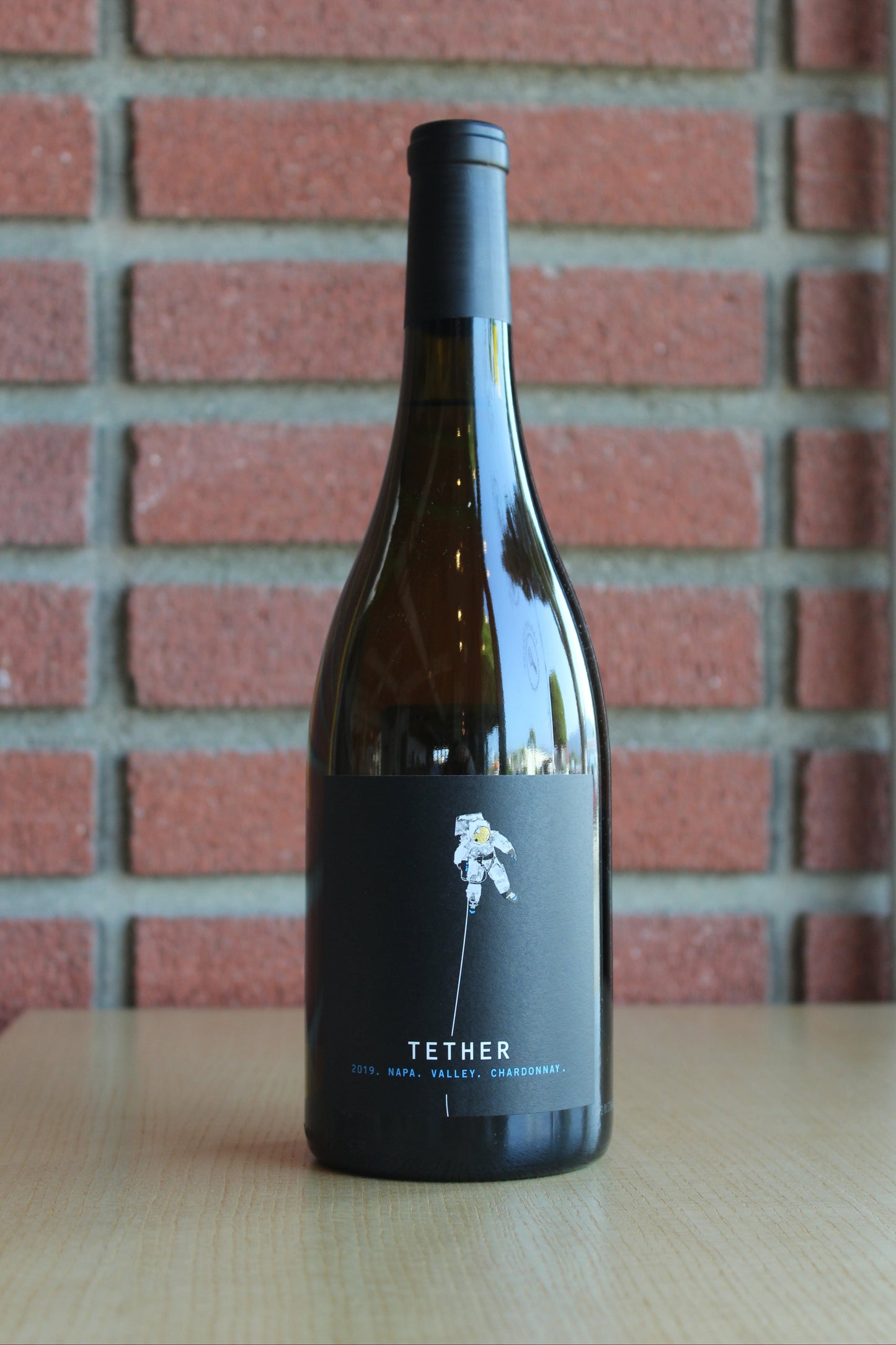 tether-chardonnay-napa-valley-bottle on a brick background