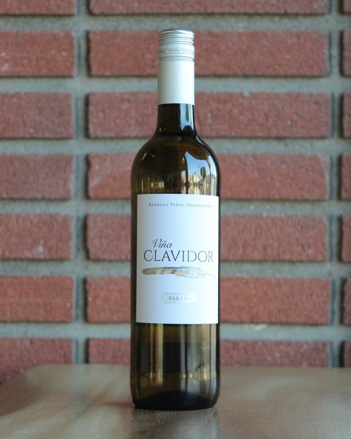 Bottle of Vidal Soblechero Vina Clavidor Verdejo 2022 wine on a red brick background