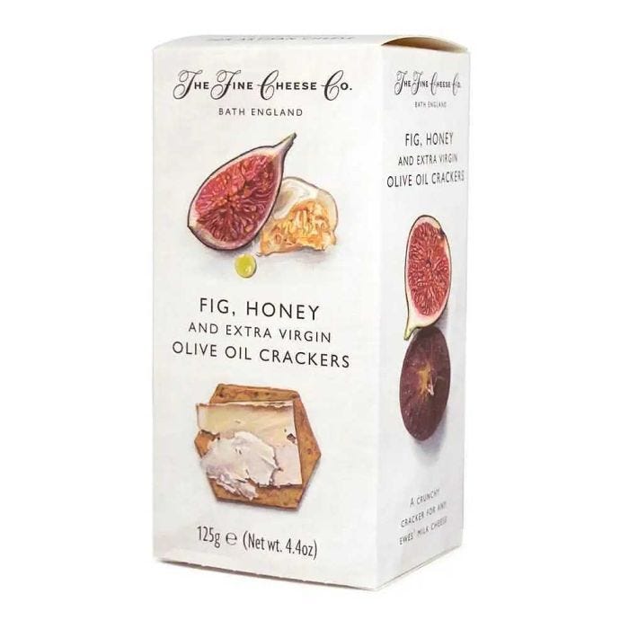 box of the fine cheese co fig , honey, olive oil crackers on a white background