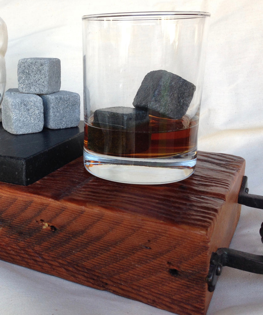soapstone chilling cubes in a glass tumbler with amber colored liquid