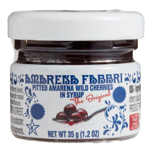 small mini jar of amaena fabbri pitted wile cherries in syrup on a white background