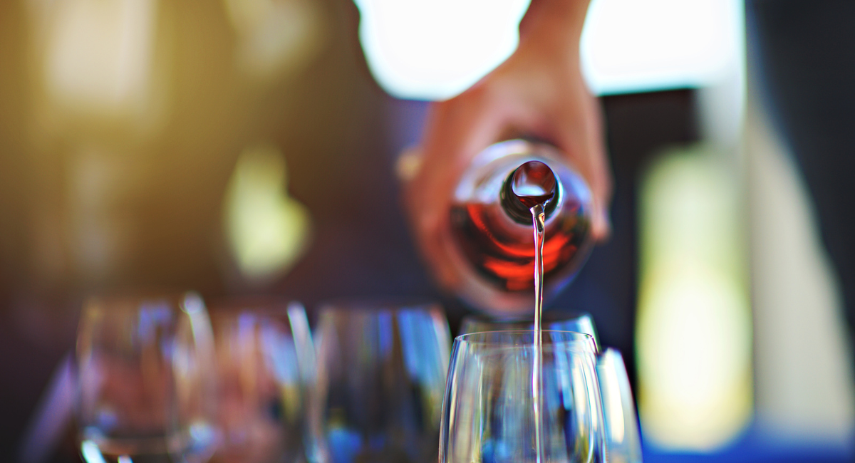 focus of a wine bottle being poured into a glass