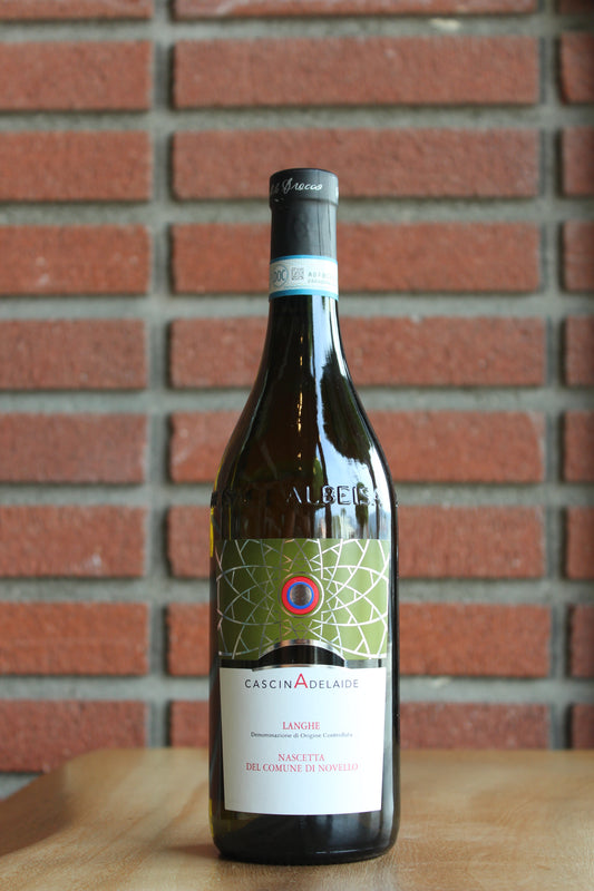 Cascina Adelaide "Nascetta" Wine bottle with label against a brick wall
