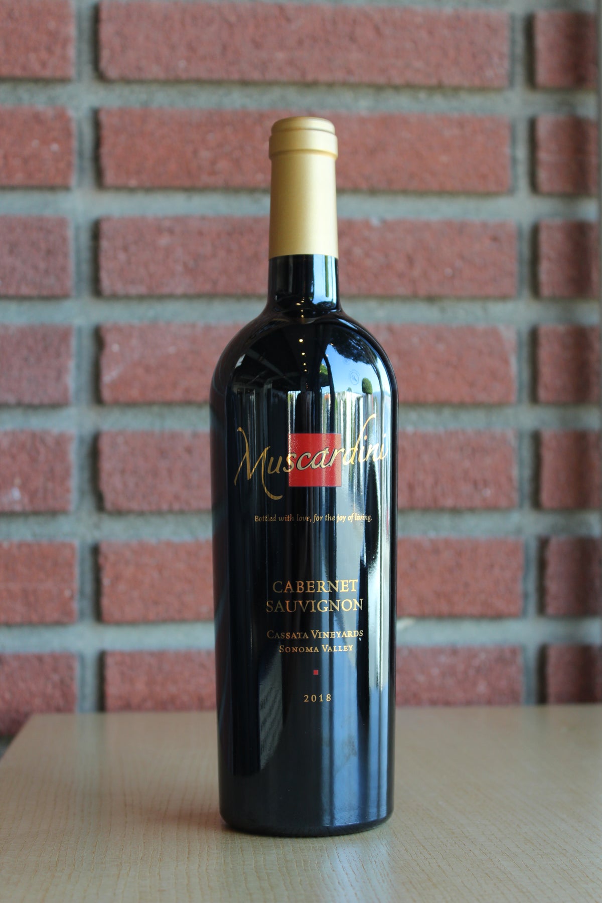 Muscardini Cellars Cassata Vineyards Cabernet Sauvignon Bottle on a brick background