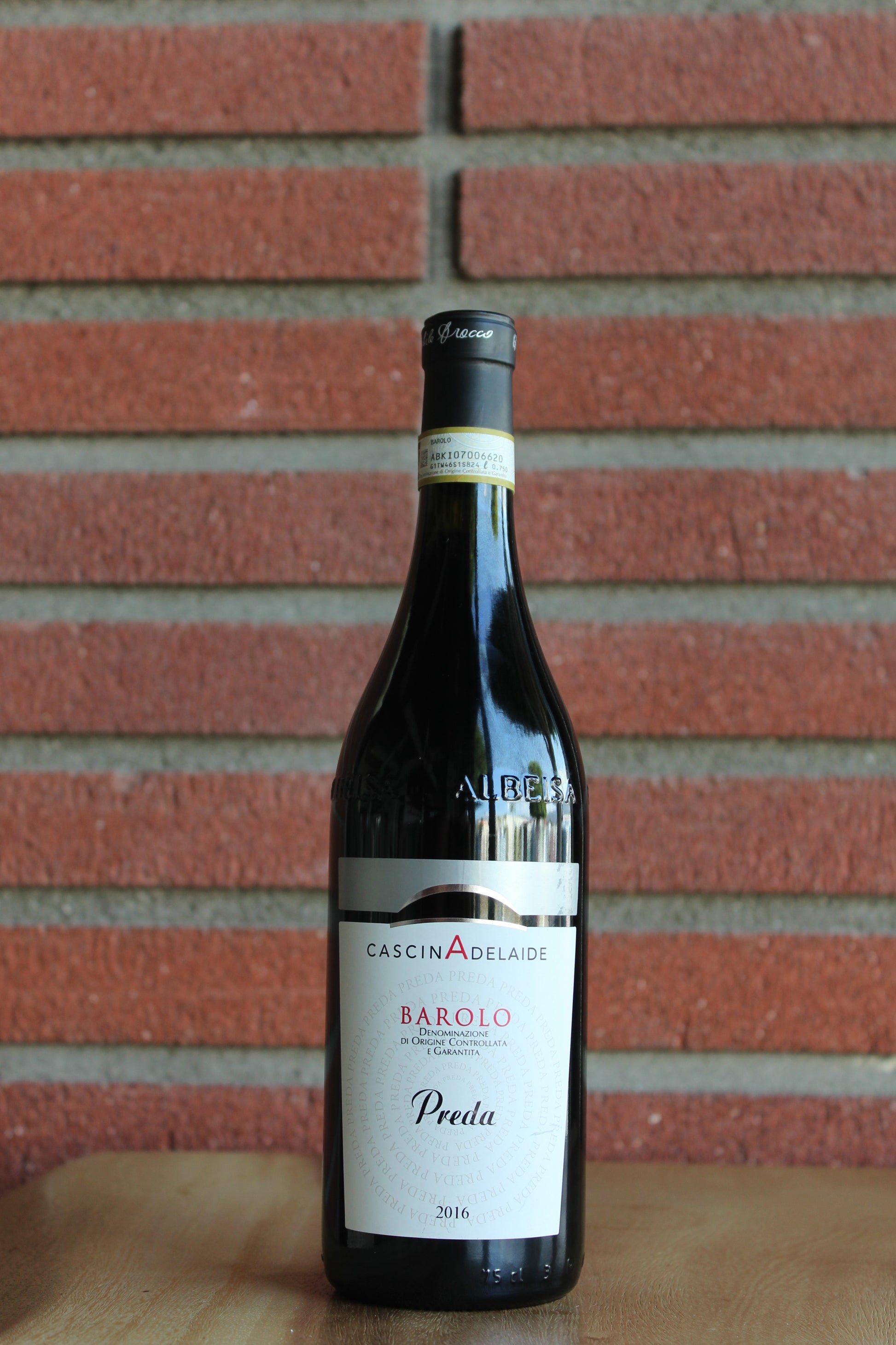 Cascina Adelaide "Preda" Barlo 2016 Wine bottle with label against a brick wall background