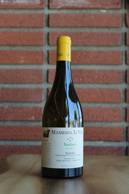 bottle of Masseria Li Veli "Askos" Verdeca on a wood surface with a red brick background
