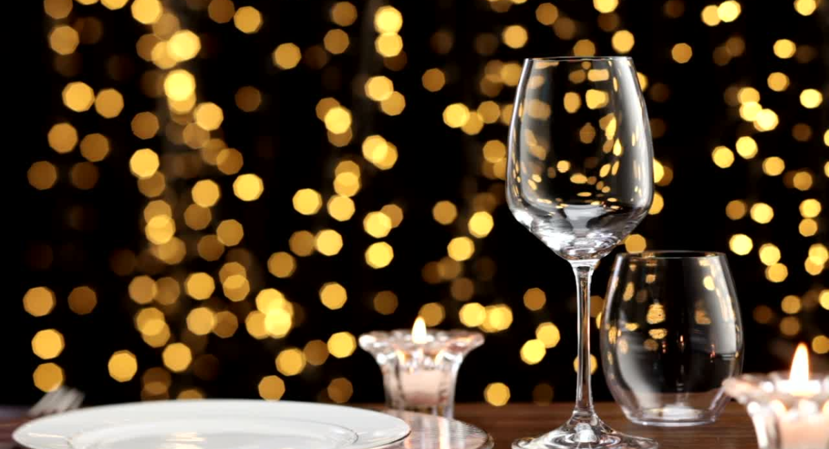 empty wine glass with gold sparkling background