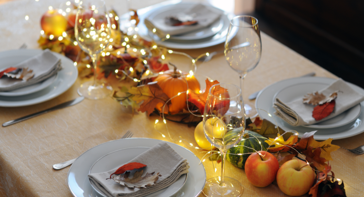 harvest tablescape with neutral place settings and empty wine glasses