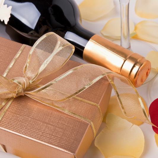 wine bottle, rose gold boxed wrapped with a riboon